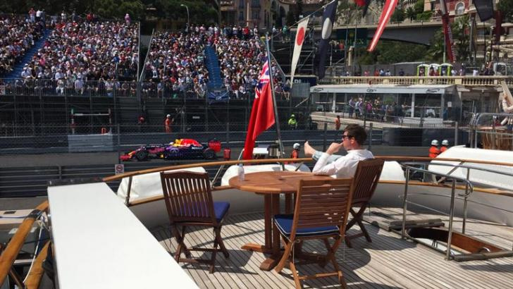 Spectator watching the Monaco Grand Prix from a trackside superyacht